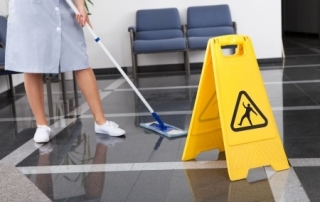 Woman mopping the floors of an office building
